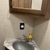 Sink and medicine cabinet in the restroom.